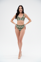 Woman wearing a green bikini with a white pattern on a white background