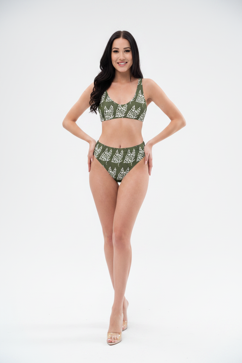 Woman wearing a green bikini with a white pattern on a white background