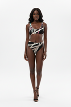 Woman wearing a colorful bikini set on a white background