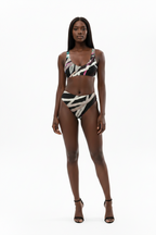 Woman wearing a patterned bikini set on a white background