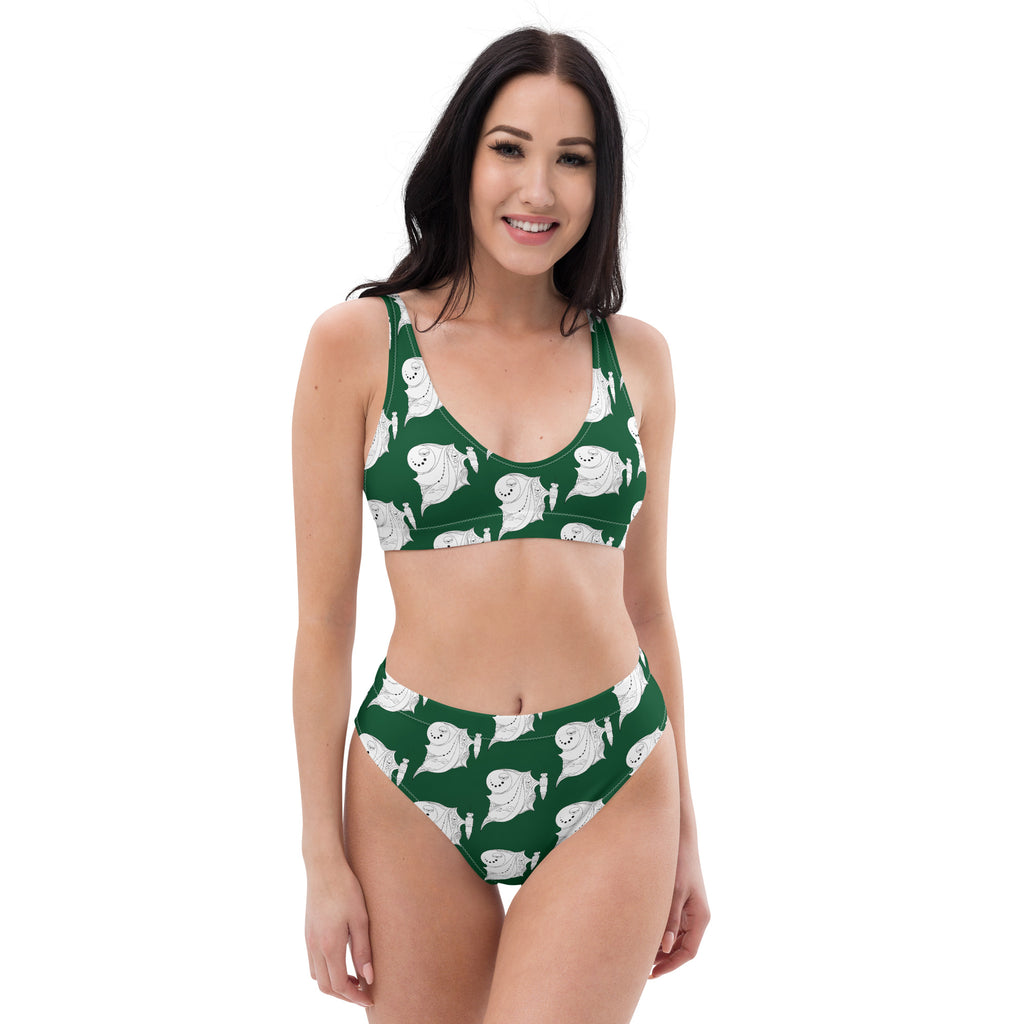 A woman smiling in a dark green high-waisted bikini with a cute white ghost print.
