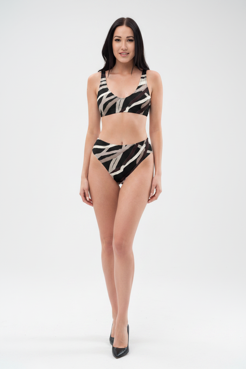 Woman wearing a black and white patterned bikini on a white background
