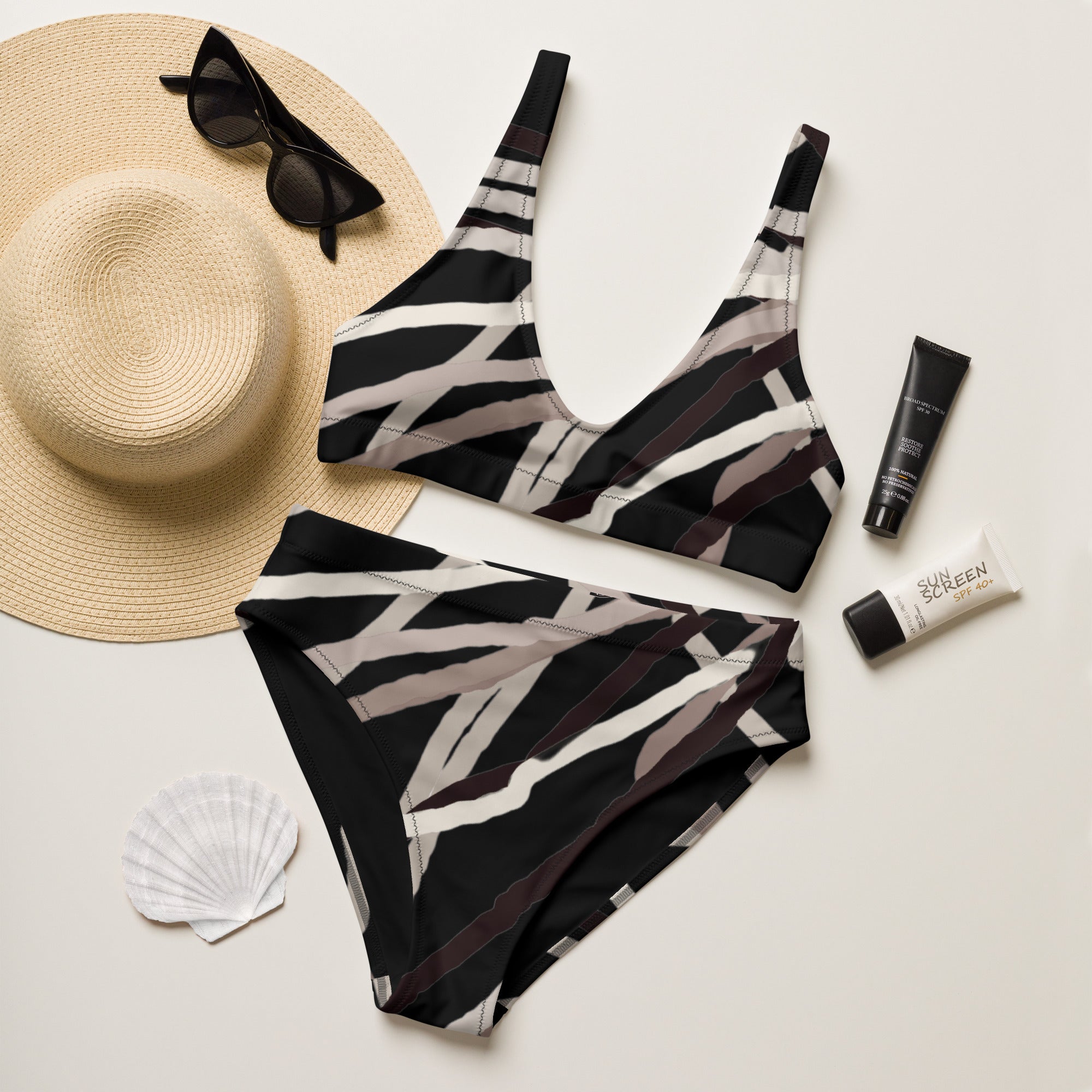 Flat lay of abstract bikini set on recycled-paper tag highlighting sustainable materials.