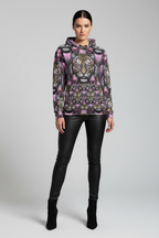 Woman wearing a patterned hoodie with a tiger design on a gray background