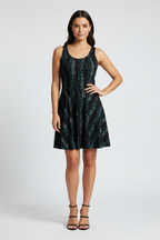 Woman wearing a black patterned dress on a white background