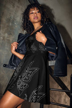 Model wearing a sleeveless black skater dress featuring an all-over white line art butterfly print from Apparelhue.