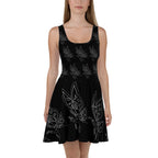 Front view of a black A-line dress with a scoop neckline and a detailed white butterfly graphic pattern.