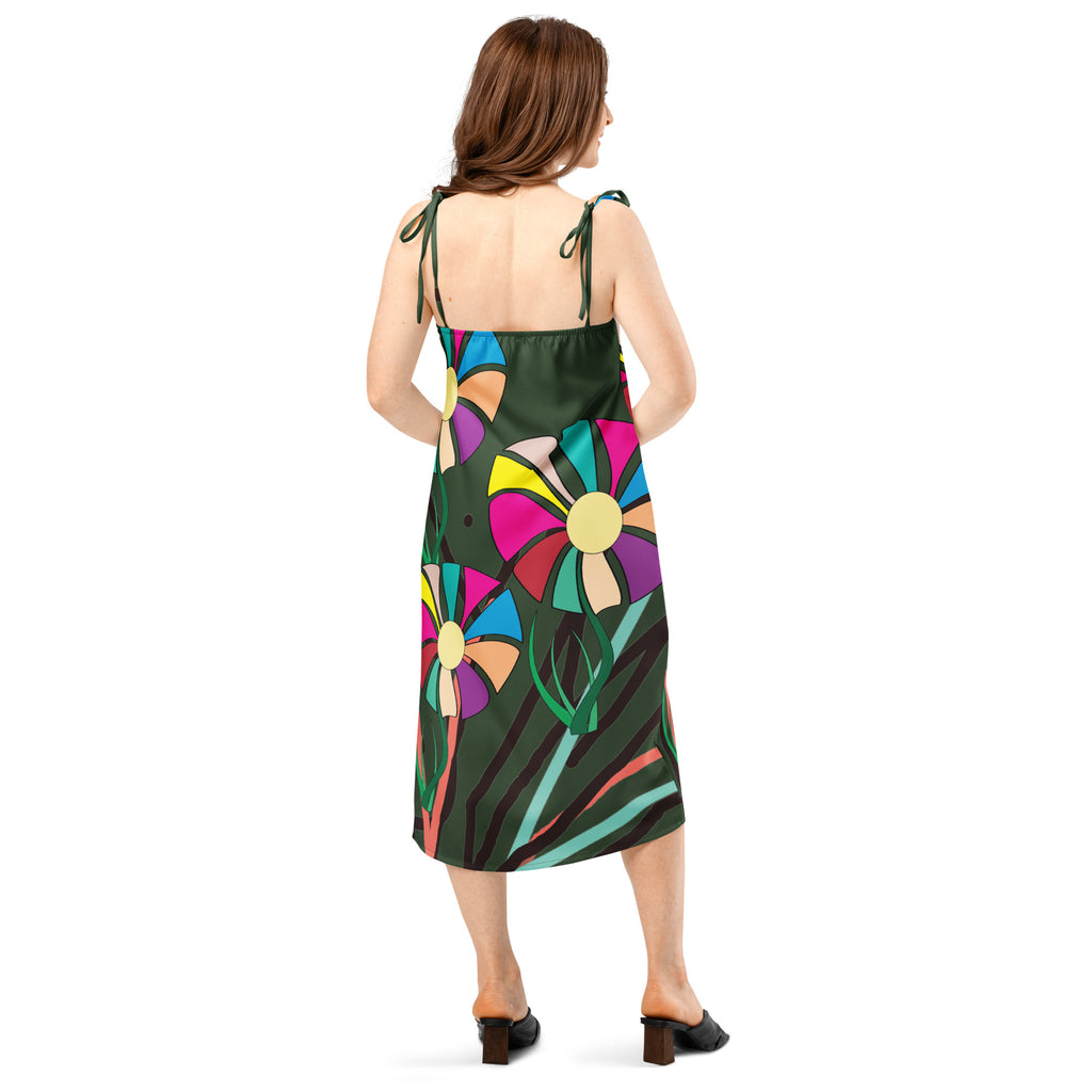 Model wearing APPARELHUE dark green slip dress featuring a bold, multi-coloured floral graphic print.