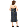 Woman wearing a black dress with a pattern of moons on a white background