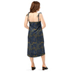 Woman wearing a black dress with a pattern of moons on a white background