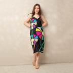 Front view of a woman modeling a v-neck, sleeveless midi dress in dark green with large, multi-colored flower prints.