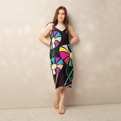 Front view of a woman modeling a v-neck, sleeveless midi dress in dark green with large, multi-colored flower prints.