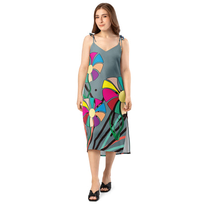 A stylish, candid shot of the woman from the side, emphasizing the dress's elegant drape and movement.