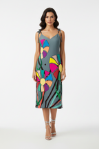 Woman wearing a colorful dress with abstract patterns on a white background