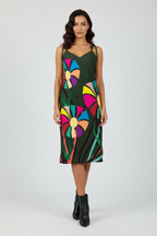 Front view of APPARELHUE all-over print slip dress with tie-up shoulder straps and large vibrant flower designs.