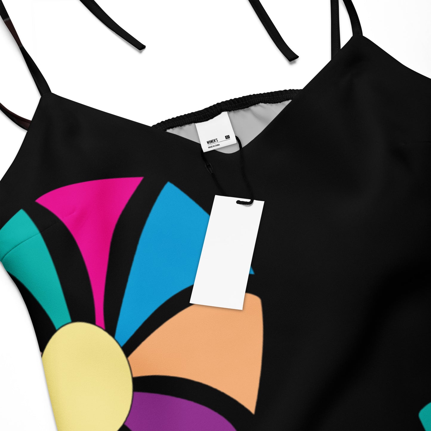 Close-up of the dress's colorful, abstract floral print on the hunter green fabric.