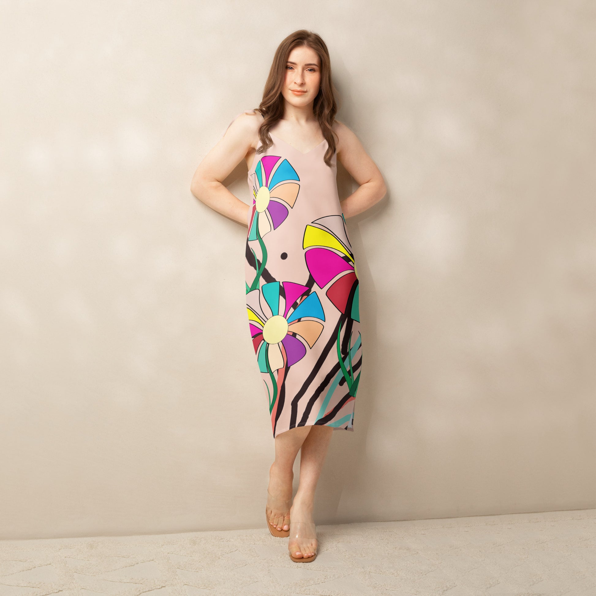 Front view of a v-neck, sleeveless midi dress in a light brown/peach hue with large, multi-colored abstract flower prints.