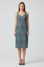 Woman wearing a patterned dress on a white background