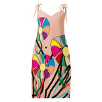 A sleeveless peach-colored slip dress with tie-shoulder straps, featuring a vibrant, multicolored abstract floral and zebra-stripe print on a solid white background.