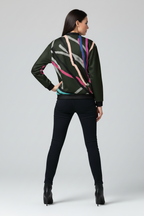 Woman wearing a patterned sweater and black pants on a white background
