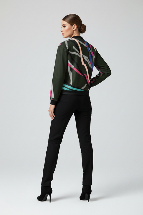 Woman wearing a stylish outfit with a colorful jacket and black pants on a white background