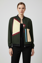 Woman wearing a modern jacket with geometric design on a plain background