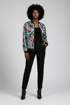 Person wearing a colorful patterned jacket on a plain background