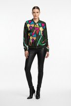 Woman wearing a colorful jacket with abstract patterns on a white background