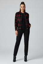 Woman wearing a black outfit with a red pattern on a white background