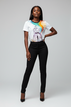 Woman wearing a white t-shirt with a colorful design and black pants on a gray background