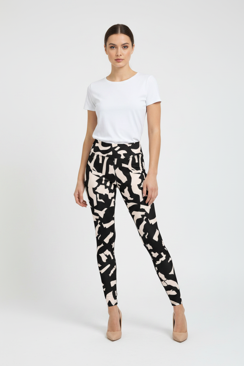 Woman wearing a white t-shirt and black and white patterned pants on a white background