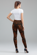 Woman wearing patterned leggings and a white top on a gray background