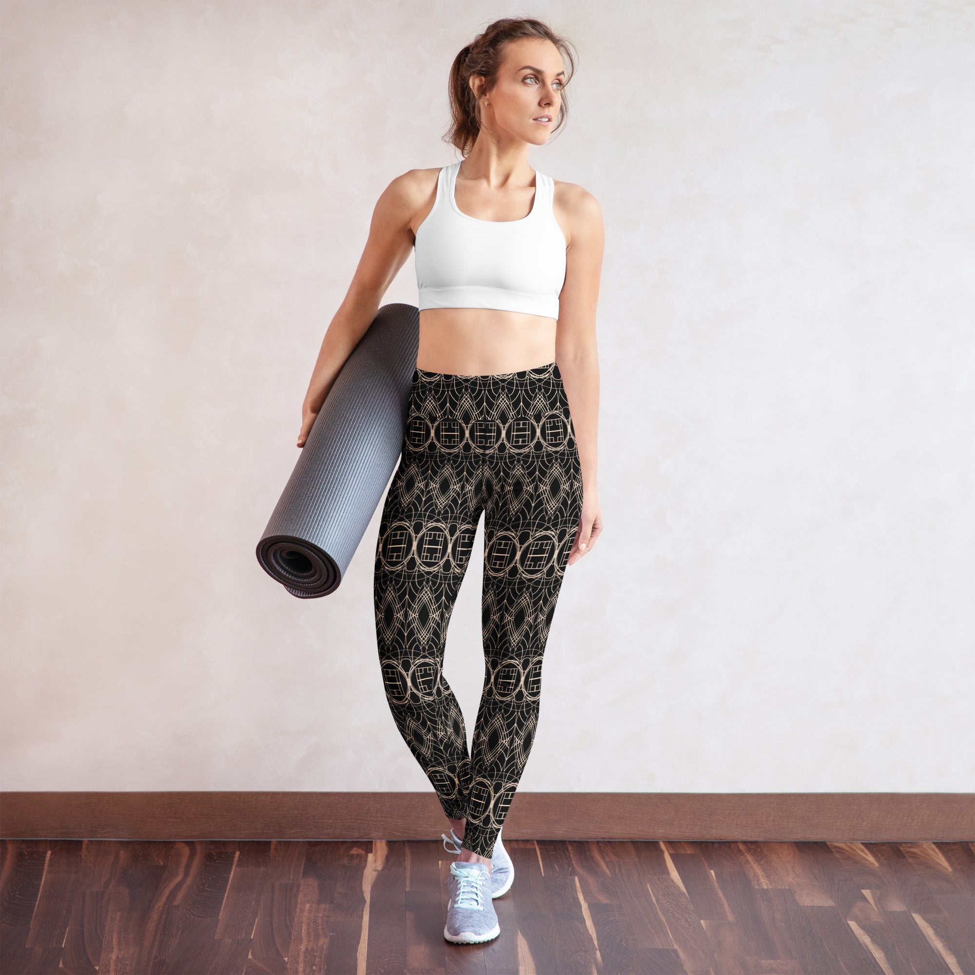 Full-body shot of a woman in the Golden Serenity leggings, holding a yoga mat