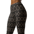  Close-up detail of the intricate gold geometric pattern on black fabric of the Golden Serenity yoga leggings.