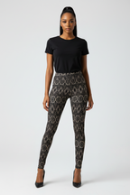 Woman wearing black t-shirt and patterned leggings on a white background