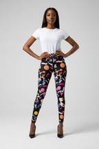 Woman wearing colorful patterned leggings with a white top on a gray background