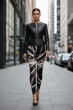 A woman walking down a city street wearing a black leather zip-front jacket and matching black, beige, and white patterned leggings.