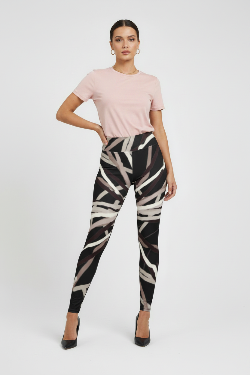 Woman wearing a pink top and patterned leggings on a white background