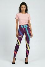 Woman wearing a pink t-shirt and colorful patterned leggings on a white background