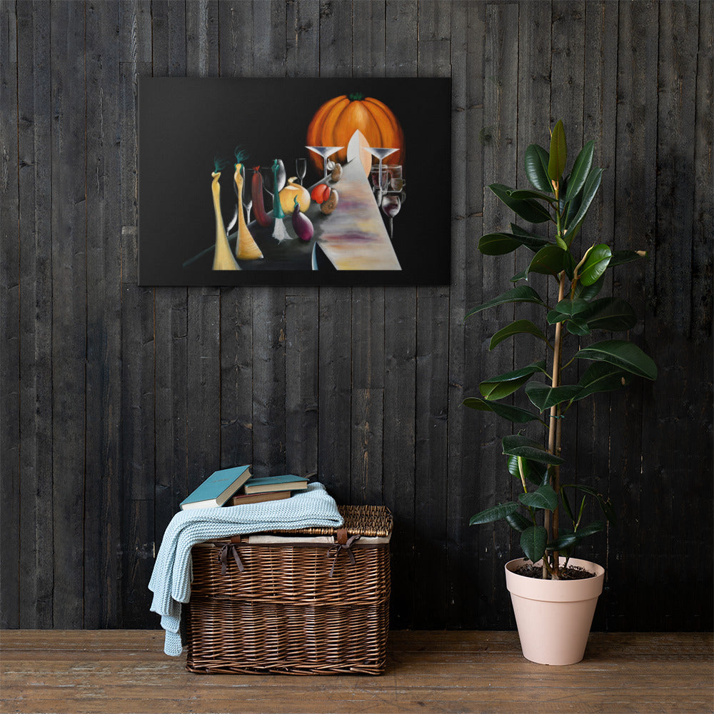 A framed abstract painting featuring a stylized orange pumpkin and a white cat on a table, displayed on a dark wood plank wall above a wicker basket with a light blue throw and a potted green plant.