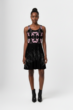 Black sleeveless dress with pink floral pattern worn by a model on a white background