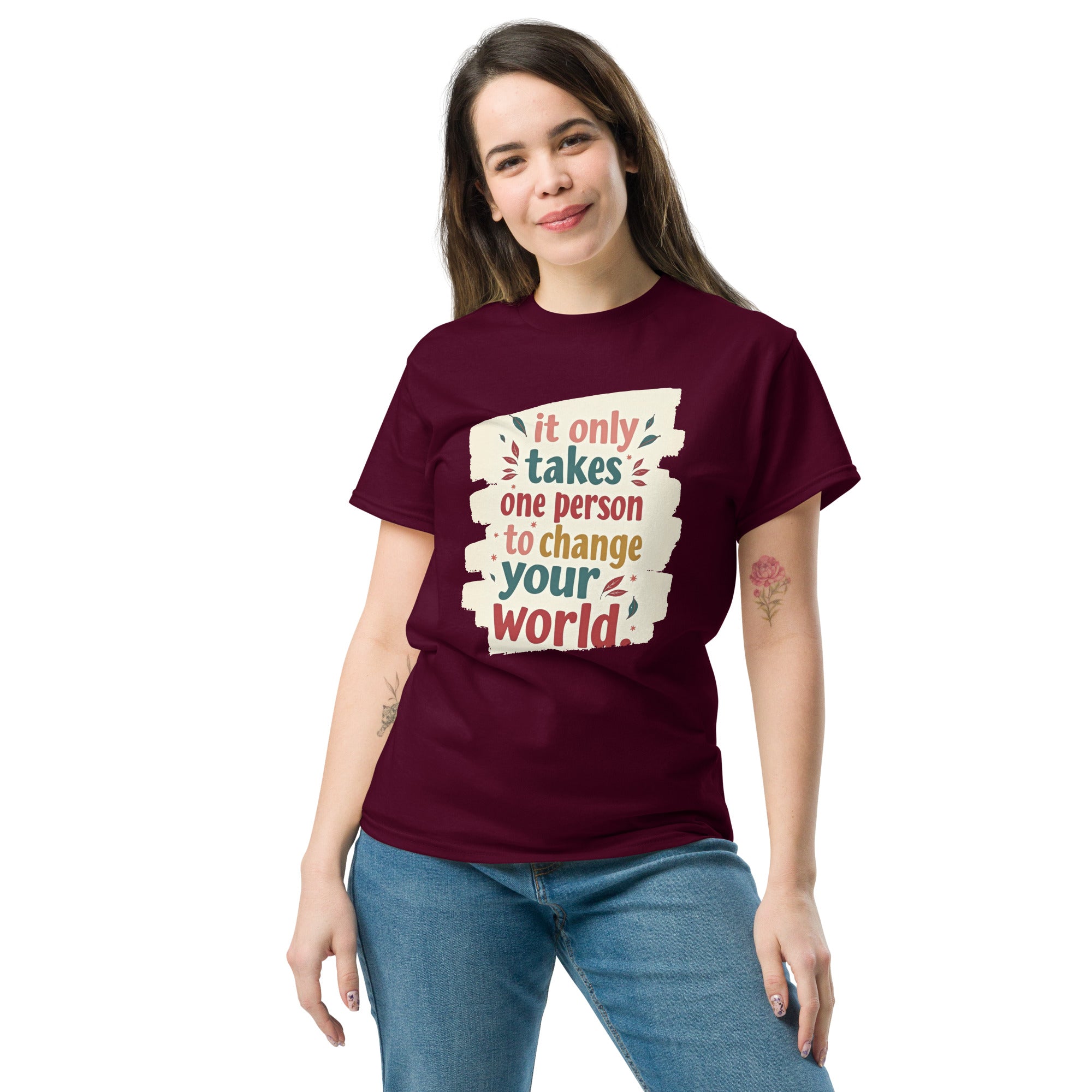 Flat lay of "One Person" inspirational shirt with denim jeans and sneakers.