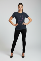 Woman wearing a dark blue t-shirt with a graphic design on a plain background