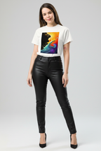 Woman wearing a white t-shirt with a colorful graphic design and black leather pants on a gray background