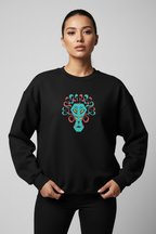 Person wearing a black sweatshirt with a colorful face design on a gray background