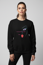 Person wearing a black sweatshirt with a graphic design and text on a gray background