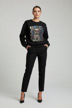 Woman wearing a black sweatshirt with a graphic design on a plain background