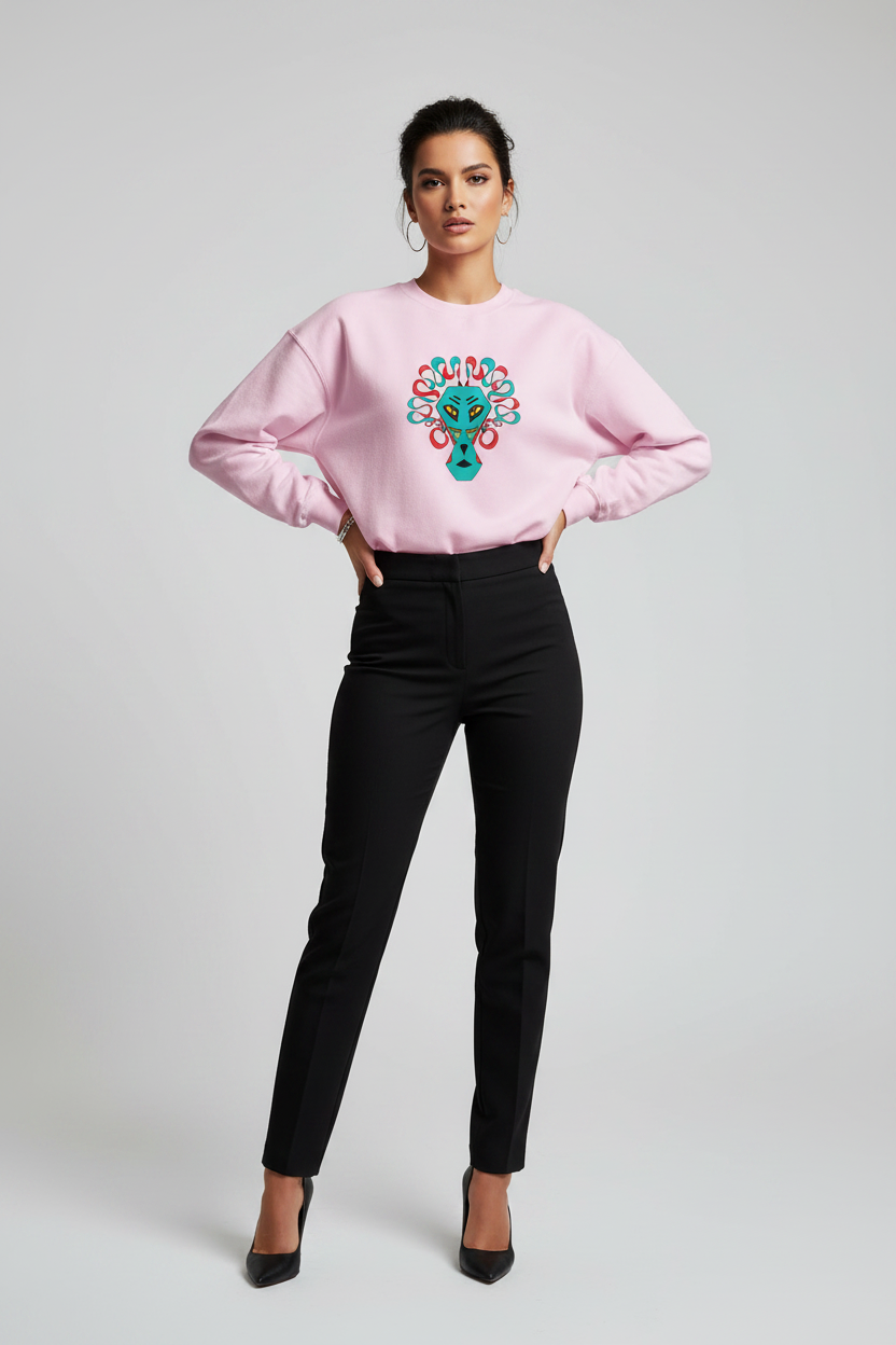Woman wearing a pink sweatshirt with a colorful design and black pants on a light gray background