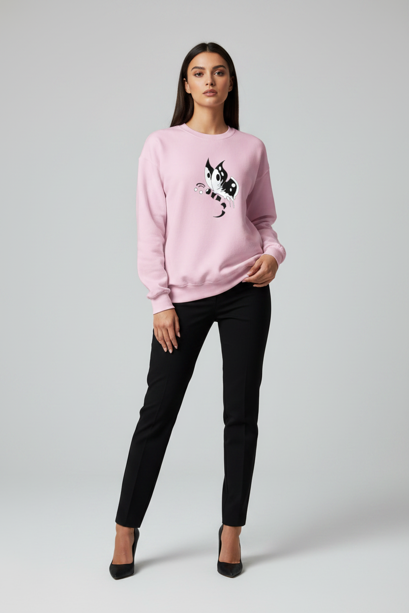 Woman wearing a pink sweatshirt with a black graphic design on a plain background