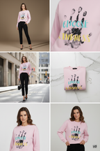 Close-up detail of the graphic on the APPARELHUE light pink crew-neck sweatshirt, showing a textured black handprint print with "CHOOSE" written in turquoise and "KINDNESS" in yellow typography.